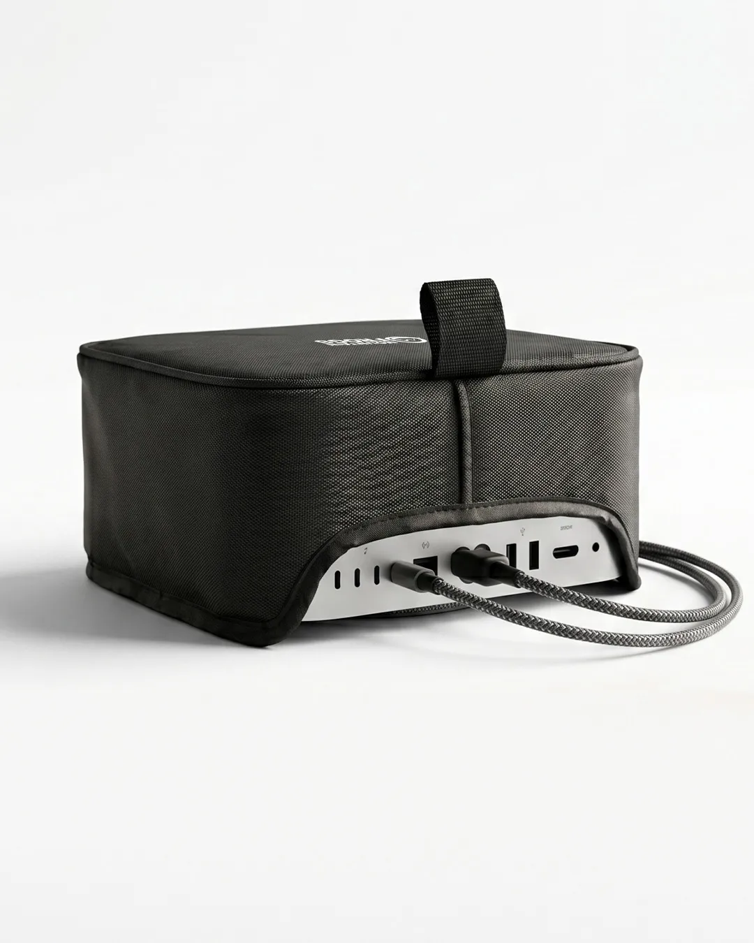 Mountain Frogs stealth black dust cover on Apple Mac Studio showing the custom rear cutout with connected cables on a clean white background.